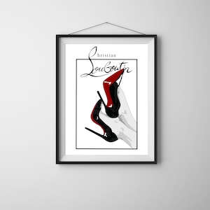 May include: A framed art print featuring a stylized illustration of two black and red high-heeled shoes. The text "Christian Louboutin" is written in elegant script above the shoes. The artwork is set against a white background.