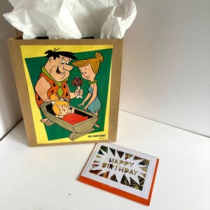 Sacola de presente e cartão comemorativo da revista em quadrinhos dos Flintstones