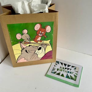 Sacola de presente e cartão comemorativo da revista em quadrinhos Tom e Jerry