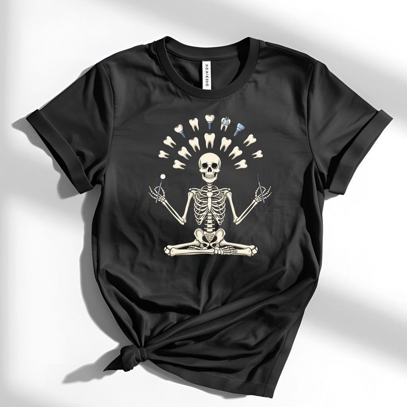 May include: Black t-shirt with a skeleton meditating, encircled by teeth and dental instruments. The skeleton holds a dental probe and mirror. A humorous design related to dentistry.