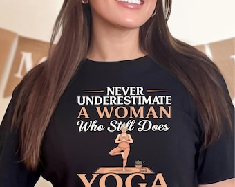 Never Underestimate A Woman Who Still Does Yoga Shirt, Yoga In Her Seventies Tee, Funny Senior Yoga Lady T‑Shirt, Yoga Grandma Gift