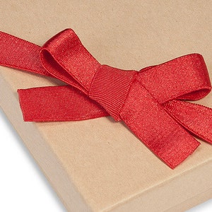 May include: A red satin ribbon tied in a bow on a brown paper gift box.