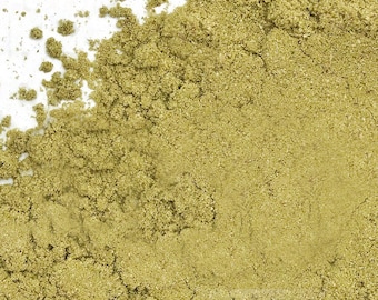 May include: Close-up of a pile of finely ground, light green powder. The powder has a slightly coarse texture and appears to be evenly distributed across a white surface. The color is a muted, earthy green.