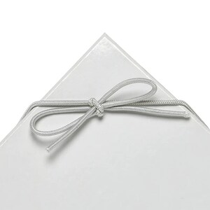 May include: A white gift box with a silver ribbon tied in a bow.