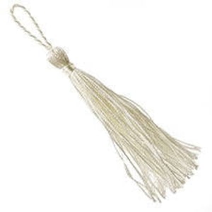 May include: A single, off-white tassel with a looped top and a bulbous knot. The tassel's strands are long and flowing, creating a soft, textured appearance. The background is plain white, highlighting the tassel's delicate details.