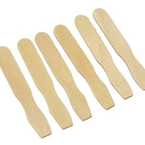 May include: Set of seven wooden craft sticks, ideal for stirring paint, glue, or other craft supplies. The sticks are approximately 6 inches long and have a rounded end.
