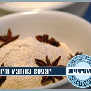 May include: A white bowl filled with warm vanilla sugar and star anise. The bowl is on a white surface. The text "warm vanilla sugar" is visible in the image. The text "CandleLynn.com approved scents" is visible in the image.