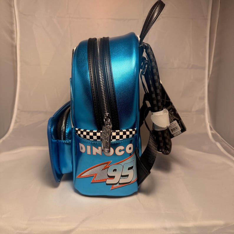 May include: A white ceramic mug with a black handle and the text "But First, Coffee" in a black, handwritten-style font. The mug is on a white surface.