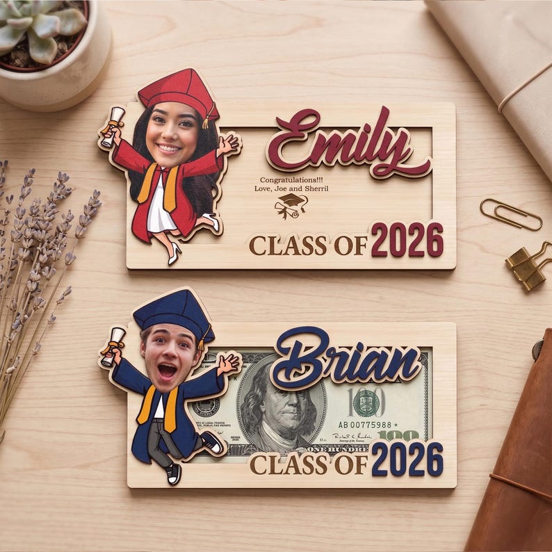 May include: Two personalized graduation photo frames. One features a cartoon image of a graduate in a red cap and gown, the name "Emily", and "Class of 2026". The other frame has a cartoon graduate in a blue cap and gown, the name "Brian", and "Class of 2026".