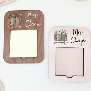 Two wooden name cards with the name 'Mrs. Clarke' written on them, each featuring a different design.