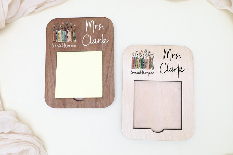 Two wooden name cards with the name 'Mrs. Clarke' written on them, each featuring a different design.