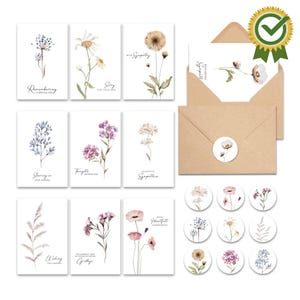 May include: A set of sympathy cards with floral watercolor designs. The cards feature various flowers in soft colors, with matching envelopes and stickers. The cards have phrases like "Remembering" and "Sorry".