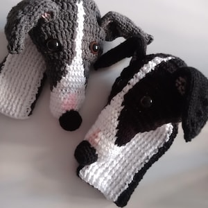 May include: Two crocheted greyhound dog plushies. One is black and white, the other is grey and white.