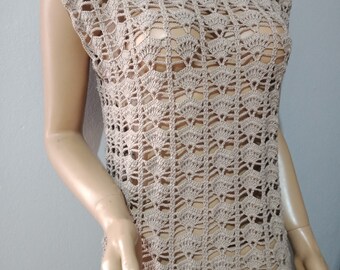 May include: A beige crochet top with a delicate openwork pattern. The top has a scoop neckline and sleeveless design.