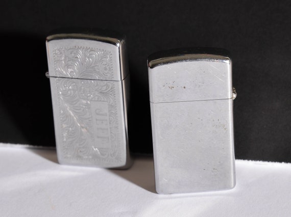 Two vintage Lighters zippo Slims 1978 Plain Stainless and engraved "Jeff" Scrolled 1991 Vintage zippo Lighters
