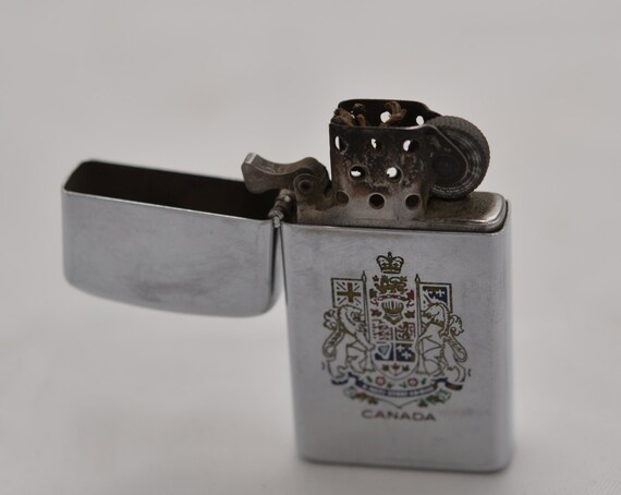 Canada 1968-70 Zipp Slim lighter Chrome ERCO Phosphate Mining Closed facility Used With Canadian Crest Advert on back Made in Canada.