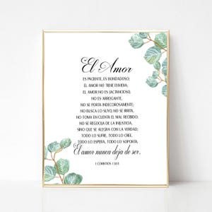May include: A framed print with the words "El Amor" in elegant script. The text is a poem in Spanish, with eucalyptus leaf accents in the corners. The frame is gold.