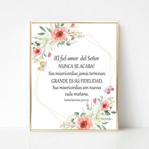 May include: A framed print with a gold border features floral arrangements and text in Spanish. The text reads "¡El fiel amor del Señor NUNCA SE ACABA!" and other verses from Lamentations 3:22-23. The floral design includes pink and white flowers.