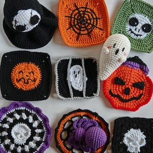 May include: A collection of handmade crochet Halloween decorations. The items include a black skull hat, orange spiderweb square, green skull square, black pumpkin square, white ghost, and a purple spider.