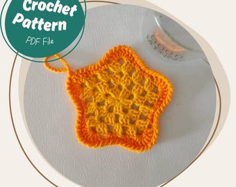 May include: A crocheted star in shades of yellow and orange. The star has a textured design and an orange border. The image also includes a teal circle with the words "Crochet Pattern PDF File".