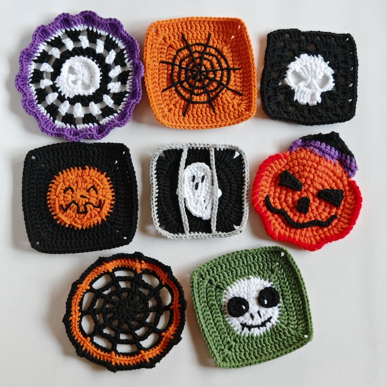 May include: A collection of handmade crochet Halloween-themed coasters. Designs include a spiderweb, a skull, a jack-o'-lantern, a ghost in a cage, and a smiling skull. The coasters are in various colors, including orange, black, white, purple, and green.