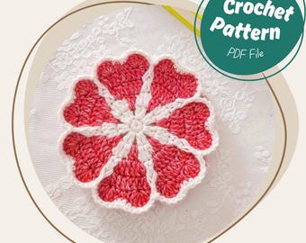 May include: A handmade crochet flower in red and white, with a heart-shaped petal design. The image includes a green circle with the text "Crochet Pattern PDF File". The flower is centered on a white, textured surface.
