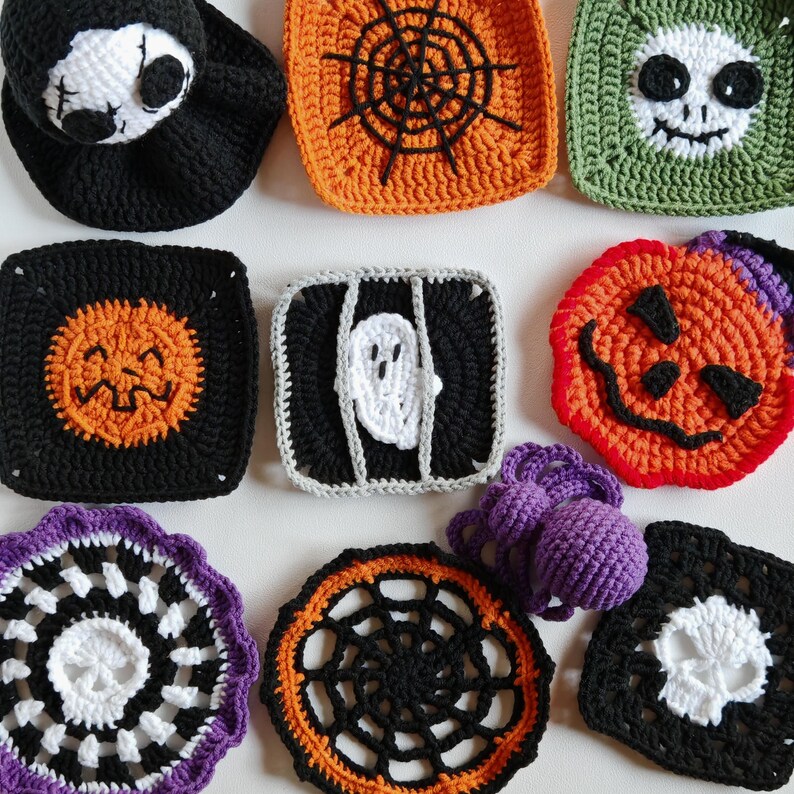 May include: A collection of handmade crochet Halloween decorations. Includes a black Grim Reaper hat, orange spiderweb square, green skull square, black jack-o'-lantern square, ghost square, and a purple crochet ball.