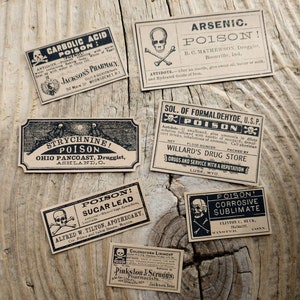 A scene showing antique reproduction label stickers from the Poison Bottle Labels sticker pack. The stickers are printed with blank ink on light brown kraft paper and are rectangular. Labels for formaldehyde, arsenic, sugar lead, strychnine, carbolic acid, corrosive sublimate and chloroform liniment are shown lying on a rustic wood surface.