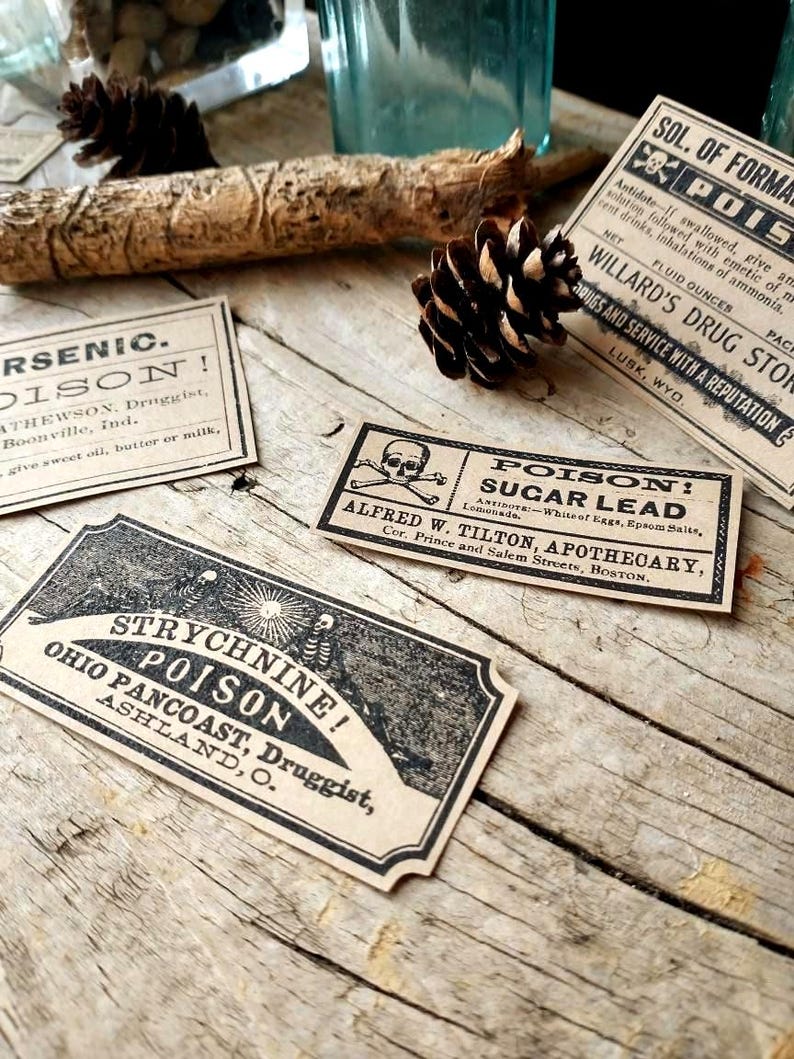 A scene showing antique reproduction label stickers from the Poison Bottle Labels sticker pack. The stickers are printed with blank ink on light brown kraft paper and are rectangular. Labels for formaldehyde, arsenic, sugar lead, strychnine, carbolic acid, corrosive sublimate and chloroform liniment are shown lying on a rustic wood surface.