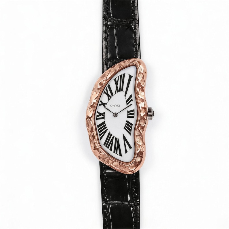 May include: A unique wristwatch with a distorted, melting-style face. The watch features a white face with black Roman numerals and a rose gold-colored bezel. The black leather band adds a classic touch. The watch is labeled "KYOSI".