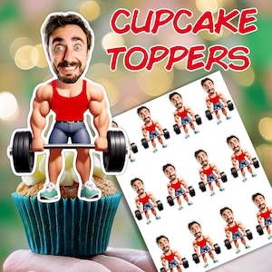 May include: A cupcake with a cartoon weightlifter topper, wearing a red vest and blue shorts, holding a barbell. A sheet of similar toppers is visible, along with the words "CUPCAKE TOPPERS" in red.
