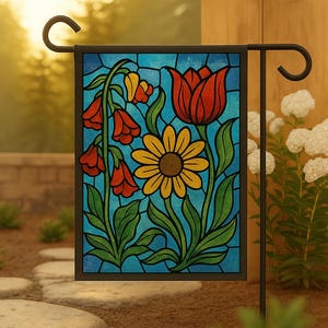 May include: A rectangular garden flag with a stained glass design featuring a red tulip, yellow daisy, and red bell-shaped flowers against a blue background. The flag is mounted on a black metal stand, perfect for outdoor decor.