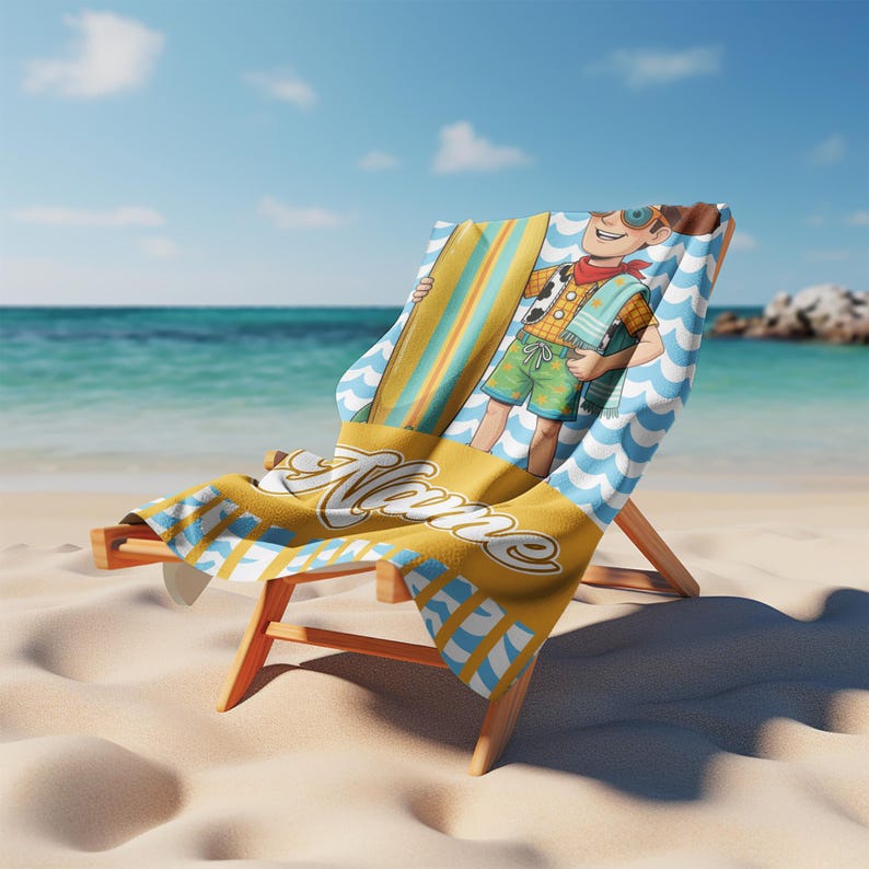 May include: A beach towel draped over a wooden beach chair, featuring a cartoon character holding a surfboard, wearing a yellow shirt, green shorts, and a red neckerchief. The towel has a blue and white wave pattern and the word Name in script.