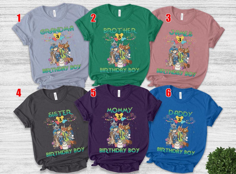 May include: Six short-sleeved crew neck t-shirts in light blue, green, mauve, dark gray, purple, and royal blue. Each shirt features a graphic of animated animal characters, a birthday cake, and the text "BIRTHDAY BOY" with a number 3.