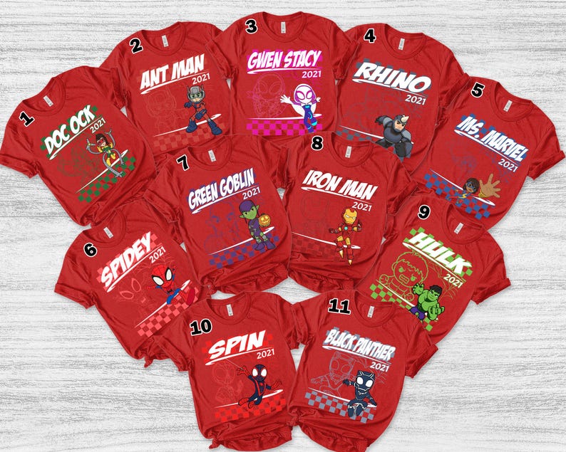 May include: A collection of eleven red t-shirts featuring various Marvel characters. Each shirt has a character name and the year 2021 printed in white. Characters include Doc Ock, Ant Man, Gwen Stacy, Rhino, Ms. Marvel, Spidey, Green Goblin, Iron Man, Hulk, Spin, and Black Panther.