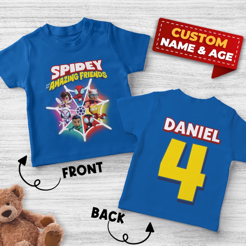 May include: Blue t-shirt featuring the text "Spidey and His Amazing Friends" with character graphics. The back of the shirt has the name "Daniel" and the number "4" in yellow. A red banner reads "Custom Name & Age."