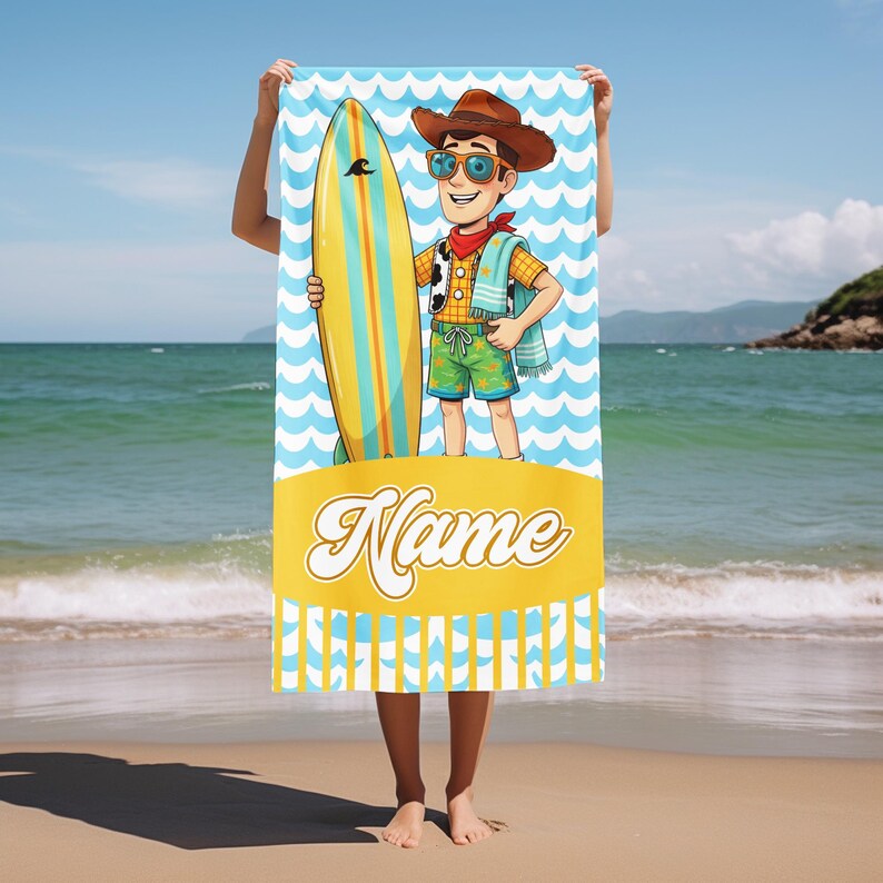 May include: A rectangular beach towel featuring a cartoon character wearing a brown cowboy hat, sunglasses, and a red neckerchief, holding a yellow and blue surfboard. The background has a light blue wave pattern and a yellow banner with the word Name.