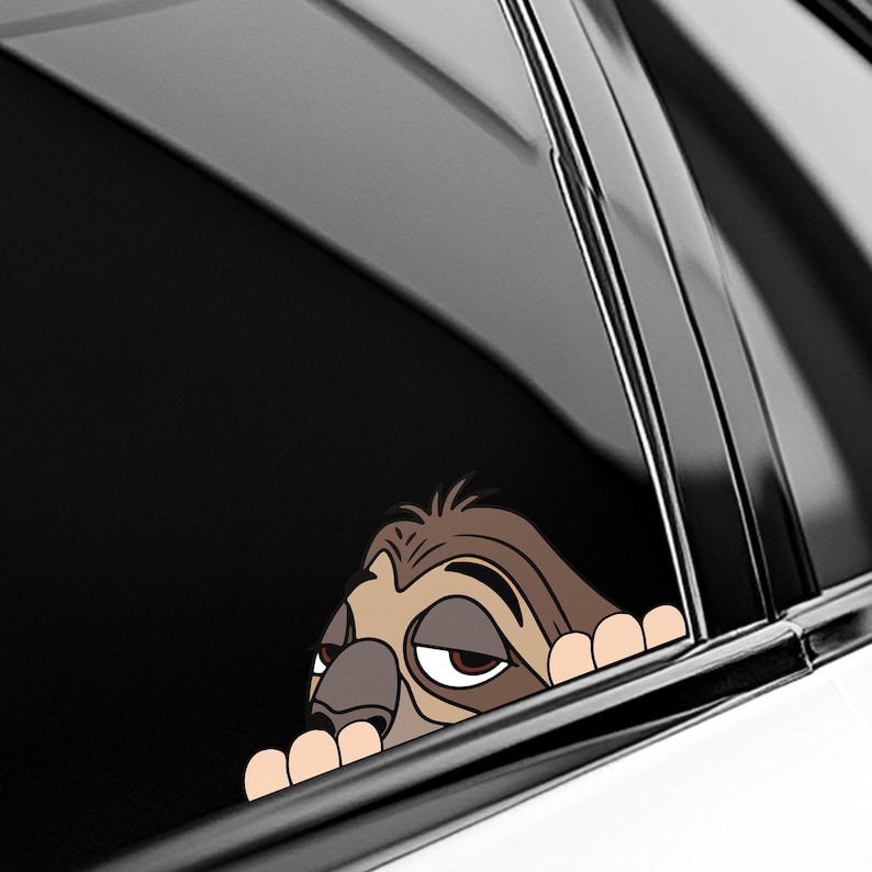 May include: A car window decal featuring a cartoon sloth peeking out. The sloth has brown fur, a gray nose, and a sleepy expression. The decal is designed to be applied to a car window.