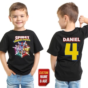 May include: Black t-shirt featuring the text "Spidey and Amazing Friends" with a graphic of the characters. The back of the shirt has the name "Daniel" and the number "4" in yellow. A red sticker says "Custom Name & Age".