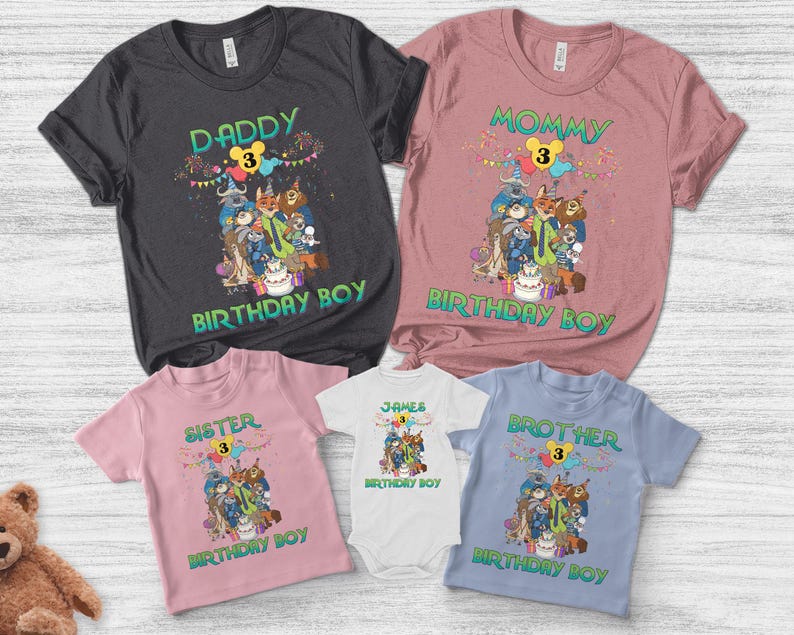 May include: A collection of five shirts and a bodysuit in charcoal, mauve, light pink, white, and light blue. Each garment features a graphic of cartoon animals, a birthday cake, balloons, the number 3, and text including DADDY, MOMMY, SISTER, BROTHER, JAMES, and BIRTHDAY BOY.