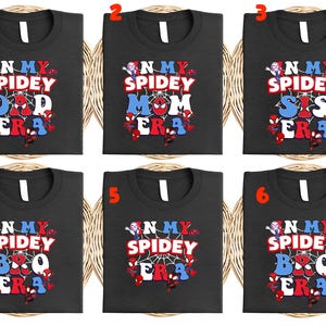 May include: Six black t-shirts with white crew necks, each featuring a colorful "N My Spidey Era" design. The designs include "Dad," "Mom," "Sis," "Bro," and two blank options, all with Spider-Man graphics.