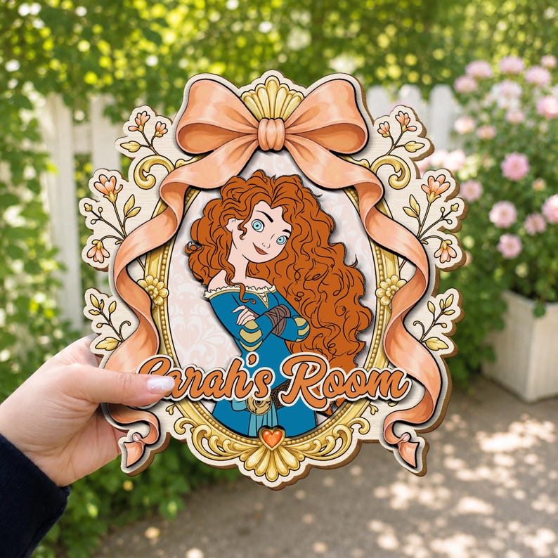 May include: A decorative wooden wall sign featuring a cartoon illustration of a girl with long curly red hair wearing a blue dress, framed by a gold border and a large peach-colored ribbon. The text Sarah's Room is printed in orange script.