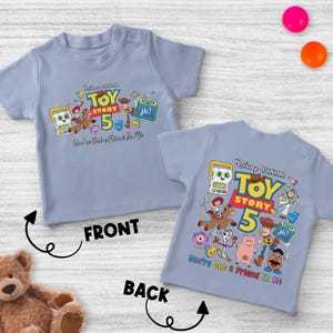 May include: Two light blue t-shirts with the Disney Pixar Toy Story 5 graphic. The front shirt has the text "You're Got a Friend In Me" and the back shirt has the same text. The shirts feature cartoon characters.