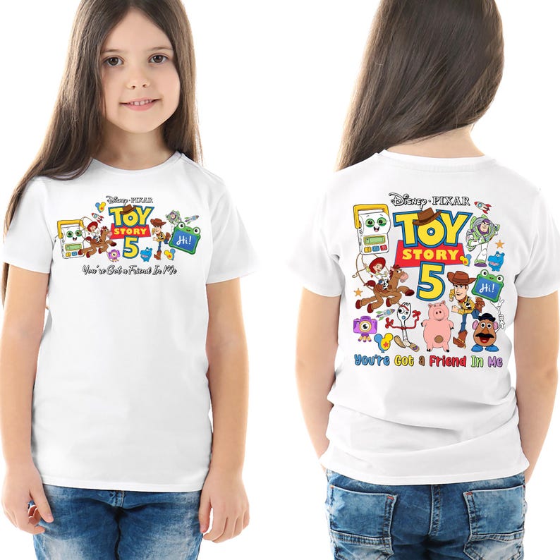 May include: White t-shirt featuring a colorful graphic of Toy Story characters, the number 5, and the text "Toy Story" and "You've Got a Friend in Me". The design is on the front and back of the shirt.
