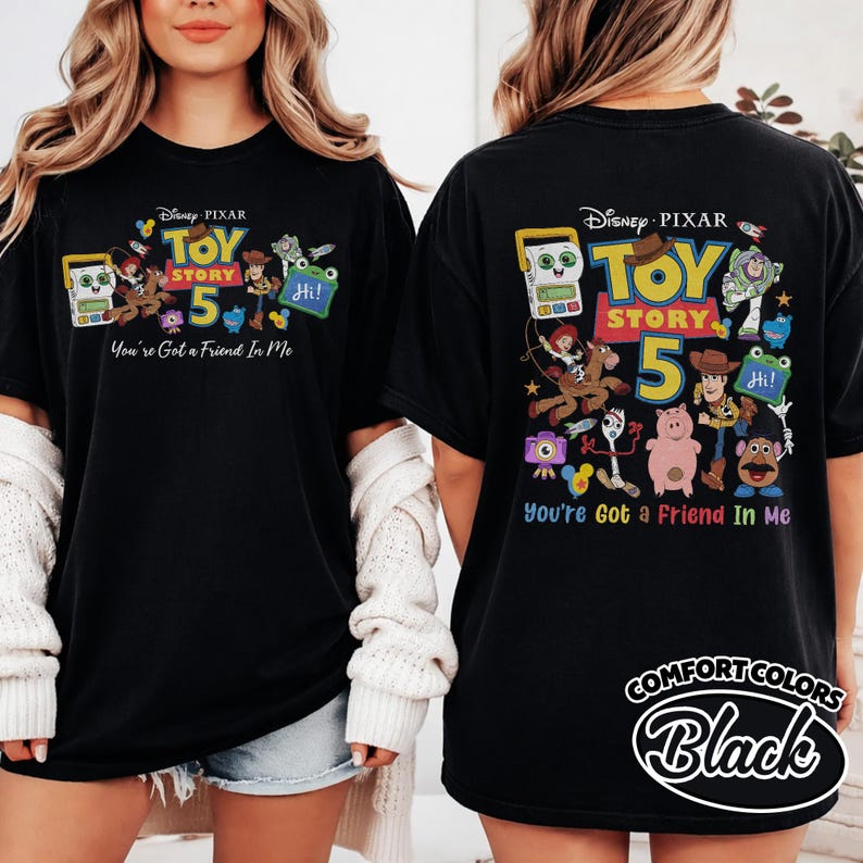 May include: Black t-shirt featuring a colorful graphic of Toy Story characters with the text "TOY STORY 5" and "You're Got a Friend In Me." The shirt also has the Disney Pixar logo.