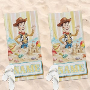 May include: Two rectangular beach towels featuring a cartoon cowboy character in a brown hat, yellow shirt, and cow-print vest. The design includes a sandcastle, beach toys, and a rectangular box at the bottom with the word NAME in yellow letters.