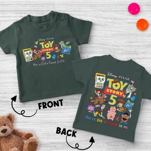 May include: Dark green t-shirts with the Disney Pixar Toy Story 5 graphic on the front and back. The graphic includes characters like Woody, Buzz Lightyear, and the text "You've Got a Friend In Me."