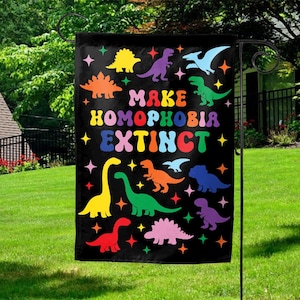 May include: Black garden flag with colorful dinosaur illustrations and the text "MAKE HOMOPHOBIA EXTINCT." The flag features various dinosaur silhouettes in yellow, purple, green, orange, and pink, with star accents. A decorative item for outdoor spaces.