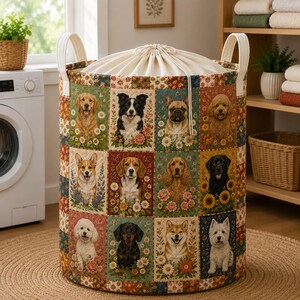 May include: A cylindrical fabric laundry hamper featuring a patchwork design of various dog breeds surrounded by colorful flowers. The hamper has two cream-colored fabric handles and a drawstring closure at the top made of off-white canvas fabric.