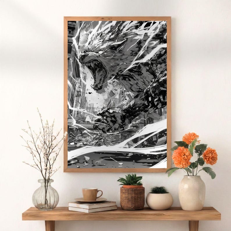 May include: Black and white framed print of a ferocious wolf-like creature, roaring with its mouth open. The artwork depicts a city in ruins, with dynamic lines suggesting movement and power. The print is displayed on a wooden shelf with decorative items.